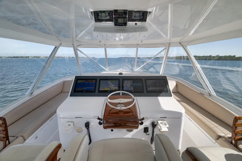 Slide: The Image of Helm of 2015 Hatteras GT70 yacht with navigation screens and panoramic ocean view. - 65