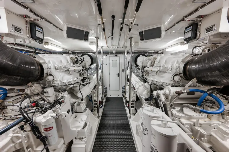 Slide: The Image of Engine room of 2015 Hatteras GT70 yacht, featuring dual engines and advanced equipment. - 85