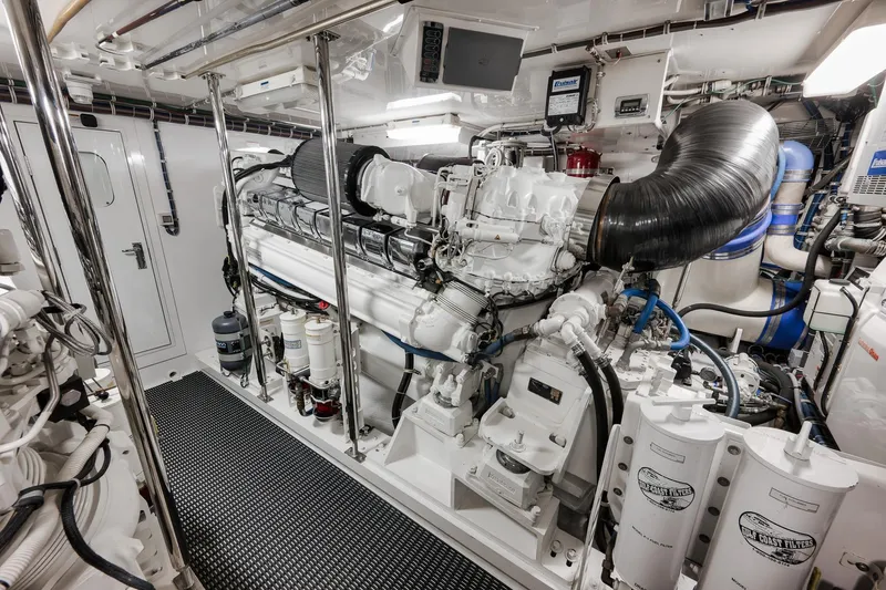 Slide: The Image of Engine room of 2015 Hatteras GT70 yacht, featuring advanced machinery and equipment. - 88