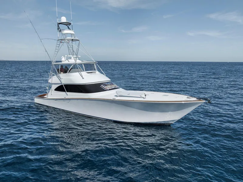 Slide: The Image of 2015 Viking 70 Convertible yacht on open sea under clear sky. - 14