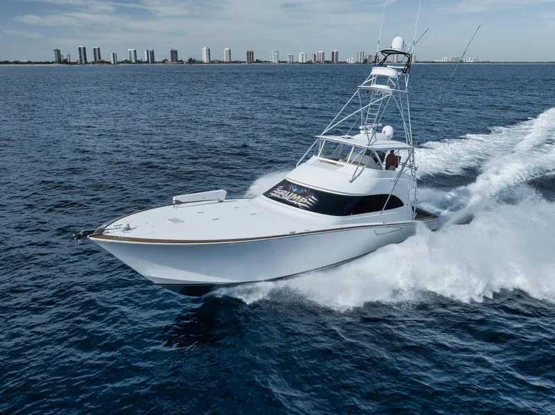 Slide: The Image of Viking 70 Convertible 2015 yacht cruising on open water near city skyline. - 4