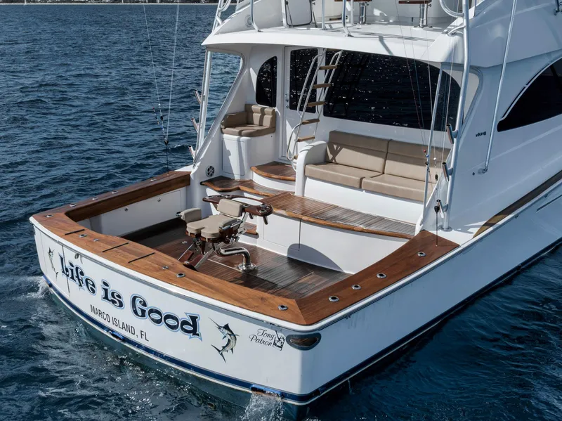 Slide: The Image of 2015 Viking 70 Convertible yacht on water, featuring spacious deck and seating. - 17