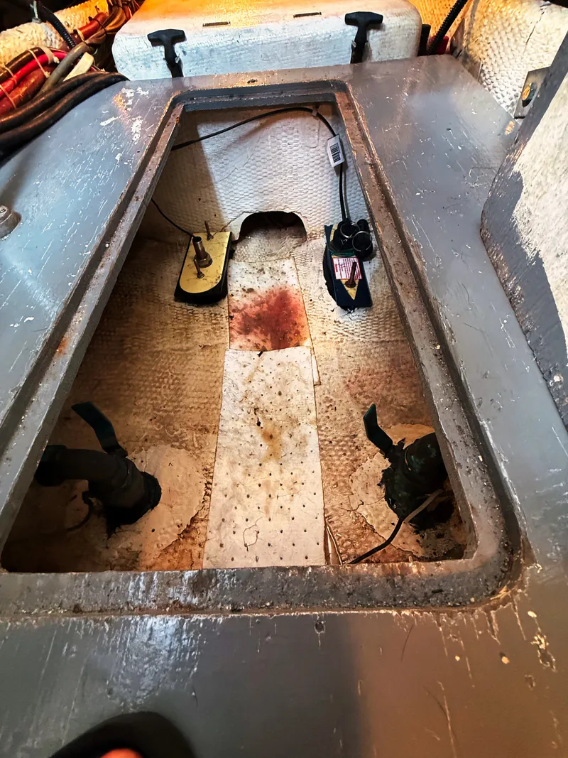 Slide: The Image of Interior view of a boat with an open floor hatch and visible pumps. - 22