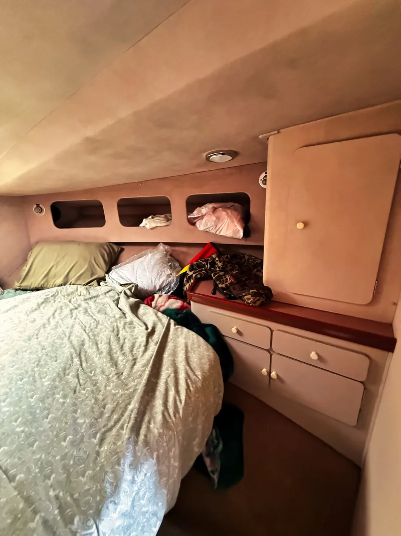 Slide: The Image of Interior of a cabin with a bed and storage space. - 13