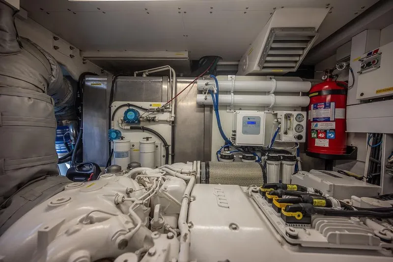 Slide: The Image of Engine room of a 2012 Sunseeker Manhattan 73 yacht, featuring mechanical equipment and fire extinguisher. - 80