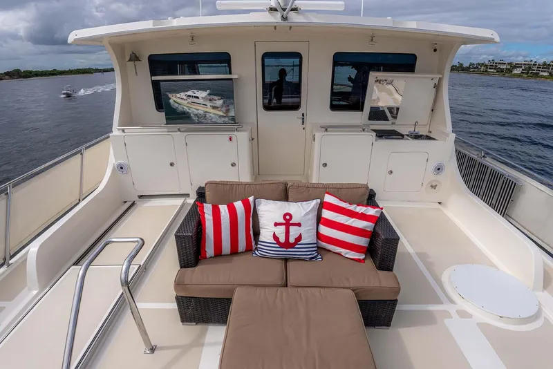 Slide: The Image of Luxurious 2006 Marlow 72E LRC yacht deck with stylish seating and nautical-themed cushions. - 51