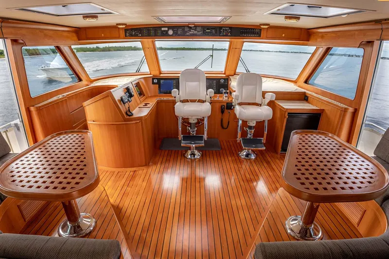Slide: The Image of Luxurious 2006 Marlow 72E LRC yacht interior with wooden flooring and dual helm chairs. - 43