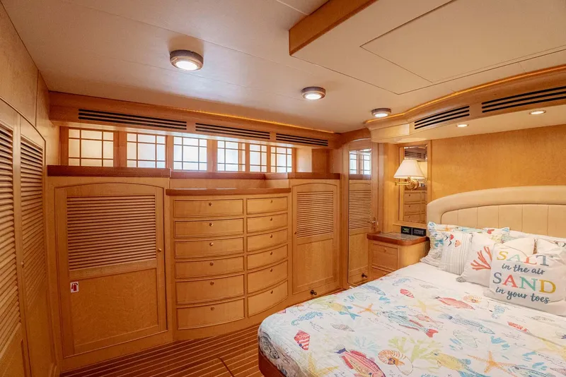 Slide: The Image of Luxurious bedroom interior of 2006 Marlow 72E LRC yacht with wooden cabinetry and cozy bedding. - 26
