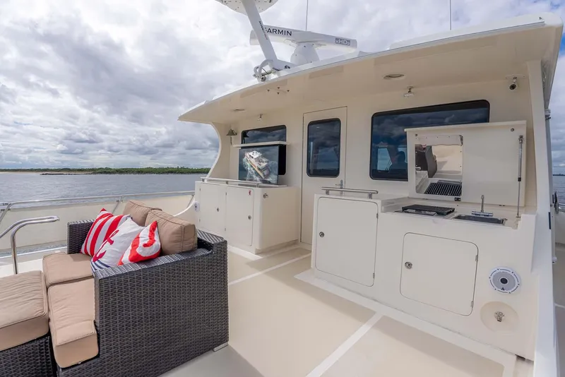 Slide: The Image of Luxurious 2006 Marlow 72E LRC yacht deck with outdoor seating and kitchen area. - 50