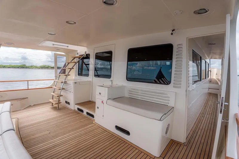 Slide: The Image of Spacious deck of 2006 Marlow 72E LRC yacht with seating and scenic view. - 8