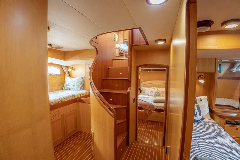 Slide: The Image of Luxurious 2006 Marlow 72E LRC yacht interior with wooden staircase and cozy cabins. - 23