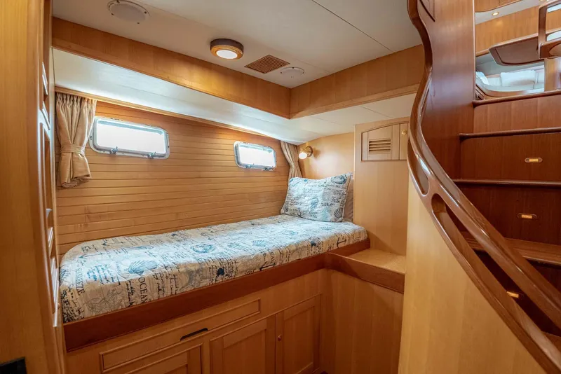 Slide: The Image of Cozy cabin interior of 2006 Marlow 72E LRC yacht with wooden finish and single bed. - 39