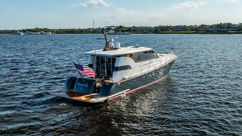 Slide: The Image of 2006 Vicem 62 Custom yacht cruising on a calm waterway with an American flag. - 7
