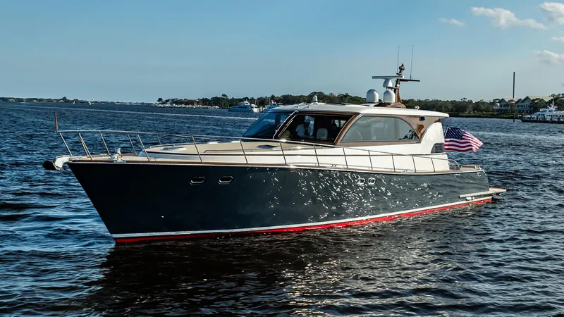 Slide: The Image of 2006 Vicem 62 Custom yacht cruising on open water, displaying sleek design and American flag. - 3
