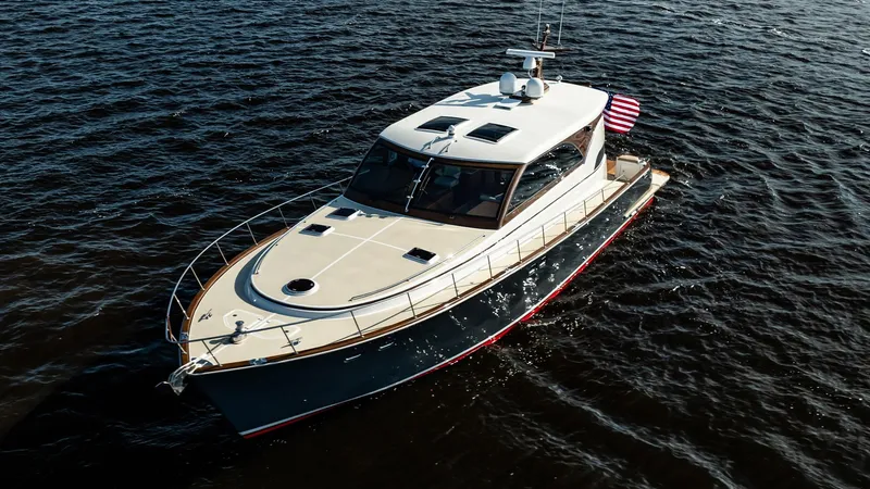 Slide: The Image of 2006 Vicem 62 Custom yacht cruising on open water, featuring sleek design and American flag. - 2