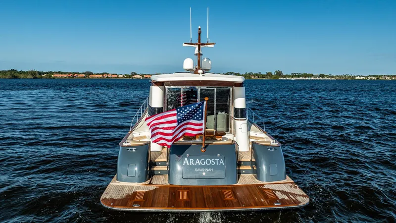 Slide: The Image of 2006 Vicem 62 Custom yacht on water, rear view with American flag. - 13