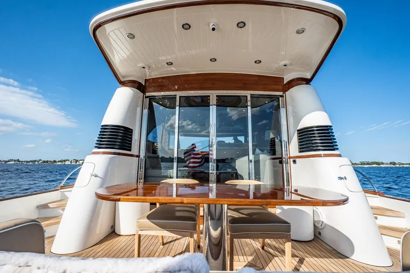Slide: The Image of 2006 Vicem 62 Custom yacht, elegant deck view with table, chairs, and ocean backdrop. - 19