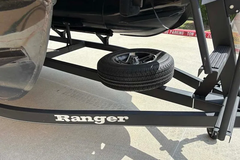 Slide: The Image of 2024 Ranger Reata 220F trailer with spare tire on concrete surface. - 10