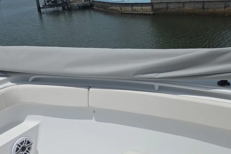 Slide: The Image of 2025 Sea Hunt Gamefish 27CB boat interior with cushioned seating and water view. - 19