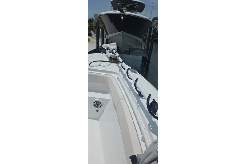 Slide: The Image of 2025 Sea Hunt Gamefish 27CB boat docked, showcasing sleek design and fishing equipment. - 21