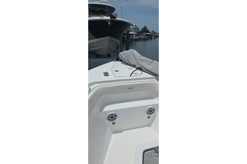 Slide: The Image of 2025 Sea Hunt Gamefish 27CB boat interior with speakers, docked near another vessel. - 17