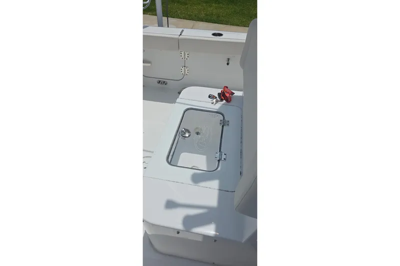 Slide: The Image of 2025 Sea Hunt Gamefish 27CB boat interior with storage compartment and seating. - 24