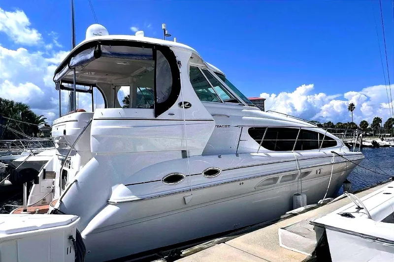 Slide: The Image of 2004 Sea Ray 390 Motor Yacht docked at marina under blue sky. - 0