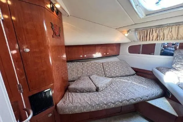 Slide: The Image of Luxurious 2004 Sea Ray 390 Motor Yacht interior with cozy seating and elegant wood finish. - 26