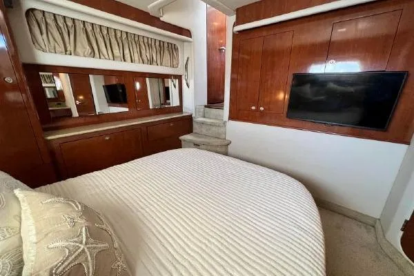 Slide: The Image of Luxurious 2004 Sea Ray 390 Motor Yacht bedroom with elegant wood finishes and modern amenities. - 20