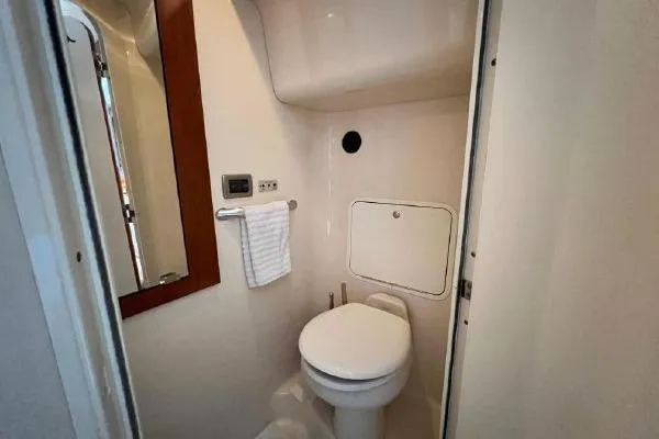 Slide: The Image of Bathroom interior of 2004 Sea Ray 390 Motor Yacht, featuring toilet and mirror. - 23