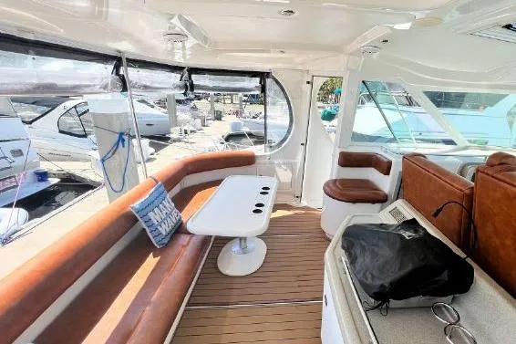 Slide: The Image of Luxurious 2004 Sea Ray 390 Motor Yacht interior with leather seating and modern amenities. - 12