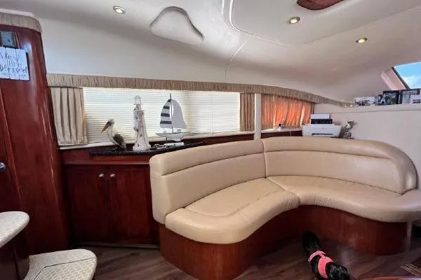 Slide: The Image of Luxurious interior of 2004 Sea Ray 390 Motor Yacht with curved seating and elegant decor. - 16