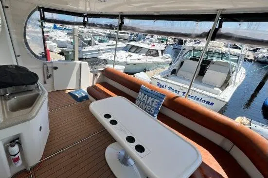 Slide: The Image of Luxurious 2004 Sea Ray 390 Motor Yacht interior with seating and marina view. - 13