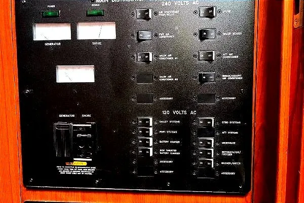 Slide: The Image of Electrical panel of 2004 Sea Ray 390 Motor Yacht with various switches and indicators. - 28