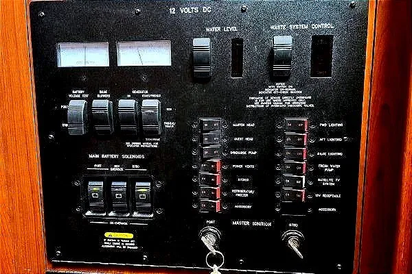 Slide: The Image of Control panel of a 2004 Sea Ray 390 Motor Yacht, featuring switches and gauges. - 29