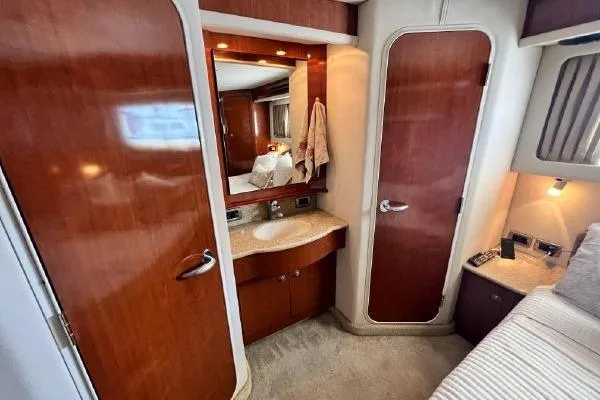 Slide: The Image of Luxurious 2004 Sea Ray 390 Motor Yacht interior with wood finish and vanity area. - 21