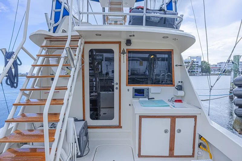 Slide: The Image of 1973 Hatteras 36 Sport Fisherman boat with wooden steps and dockside view. - 14