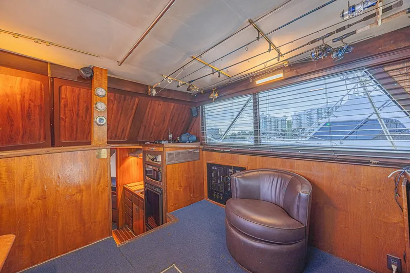 Slide: The Image of Interior of a 1973 Hatteras 36 Sport Fisherman boat with wood paneling and fishing rods. - 23