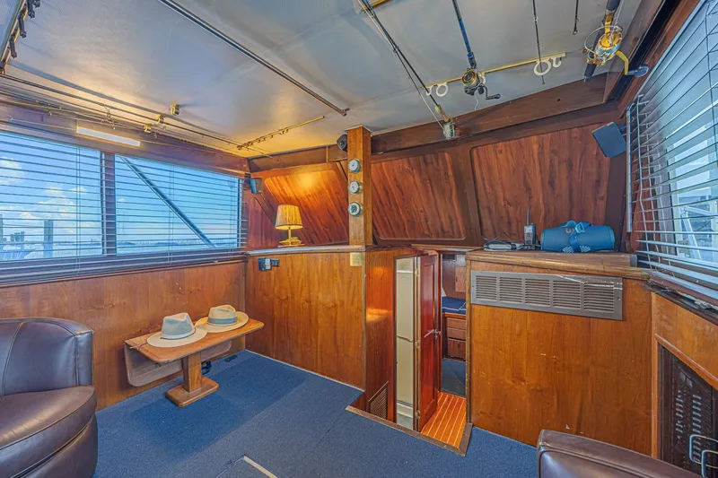 Slide: The Image of Interior of a 1973 Hatteras 36 Sport Fisherman with wood paneling and fishing rods. - 21