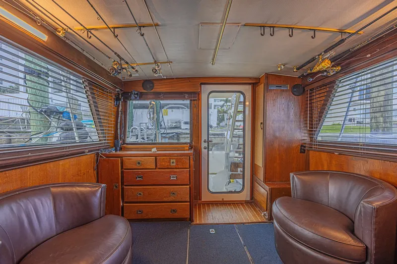 Slide: The Image of Interior of a 1973 Hatteras 36 Sport Fisherman with wood paneling and leather seating. - 22