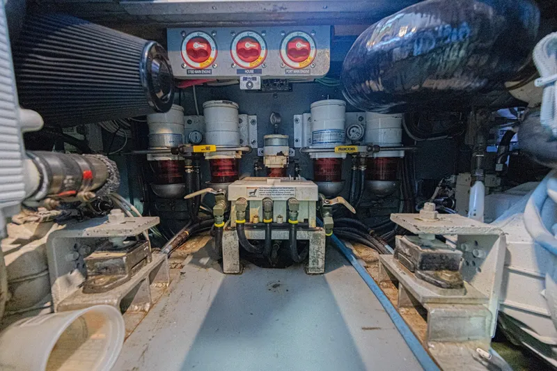 Slide: The Image of Engine room of a 1973 Hatteras 36 Sport Fisherman boat, showcasing mechanical components. - 40