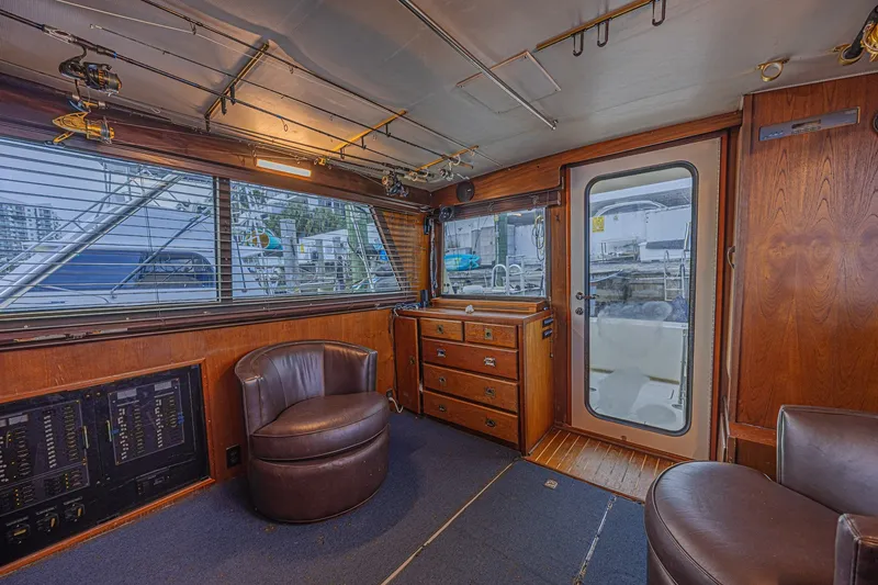 Slide: The Image of Interior of a 1973 Hatteras 36 Sport Fisherman boat with leather chairs and wooden cabinetry. - 25
