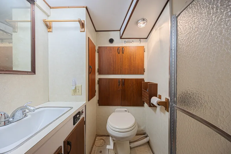 Slide: The Image of Bathroom interior of 1973 Hatteras 36 Sport Fisherman yacht, featuring sink, toilet, and shower. - 33