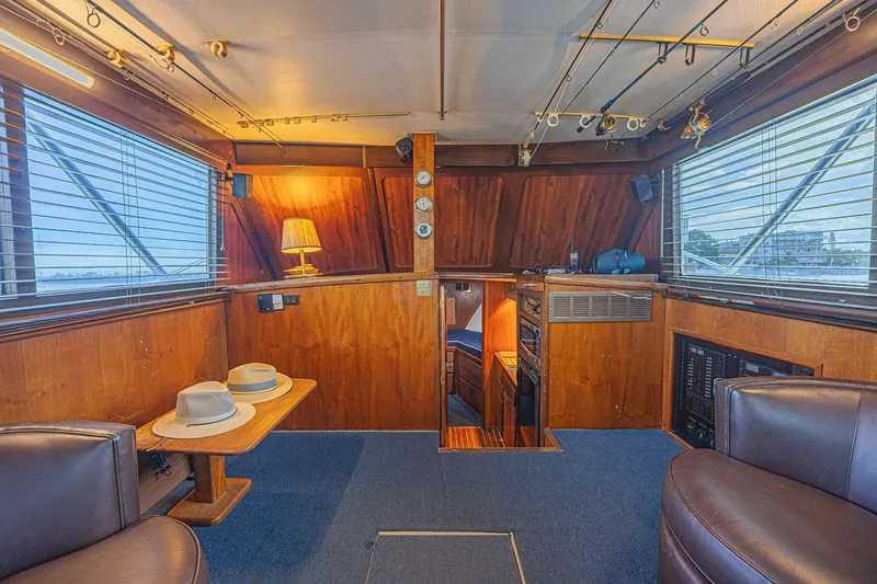 Slide: The Image of Interior of a 1973 Hatteras 36 Sport Fisherman boat with wood paneling and fishing rods. - 26