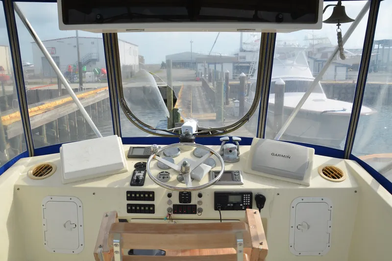 Slide: The Image of Helm of 1973 Hatteras 36 Sport Fisherman with Garmin navigation system at dock. - 15