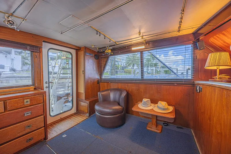 Slide: The Image of Interior of 1973 Hatteras 36 Sport Fisherman with wood paneling and cozy seating area. - 24