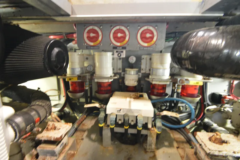 Slide: The Image of Engine room of a 1973 Hatteras 36 Sport Fisherman, showcasing mechanical components and wiring. - 43