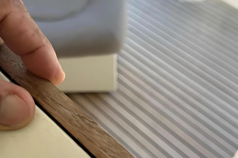 Slide: The Image of Close-up of a hand touching wood on a 1998 Ferretti Yachts 80 FLY deck. - 26