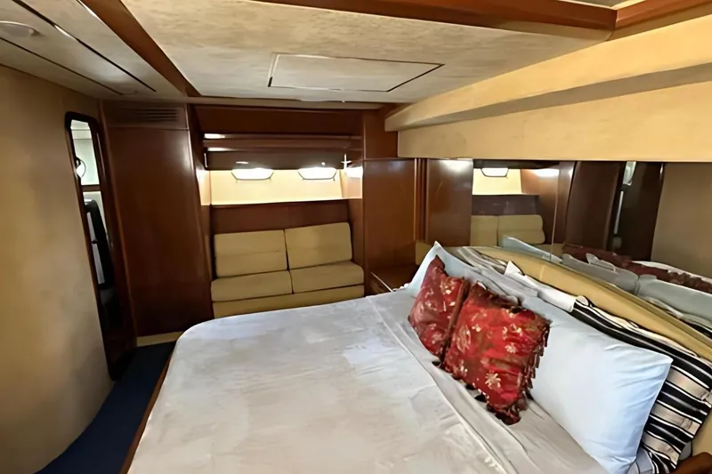 Slide: The Image of Luxurious bedroom interior of 1998 Ferretti Yachts 80 FLY with elegant wood paneling. - 22