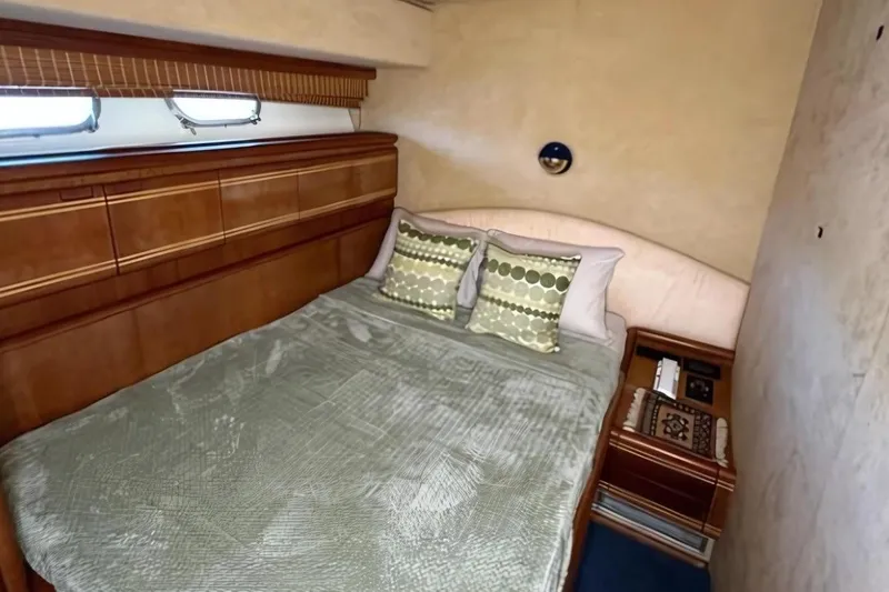 Slide: The Image of Luxurious bedroom interior of 1998 Ferretti Yachts 80 FLY with elegant wood finishes. - 23